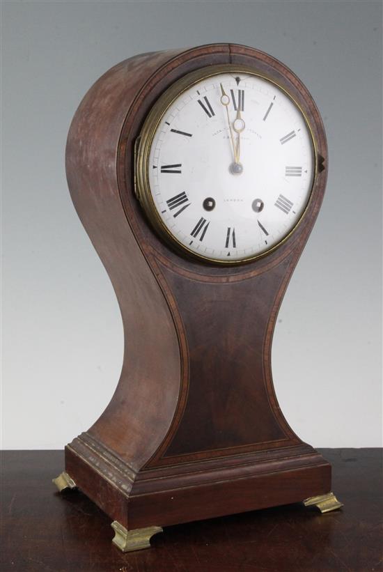 An Edwardian cross banded mahogany balloon cased mantel clock, 15in.